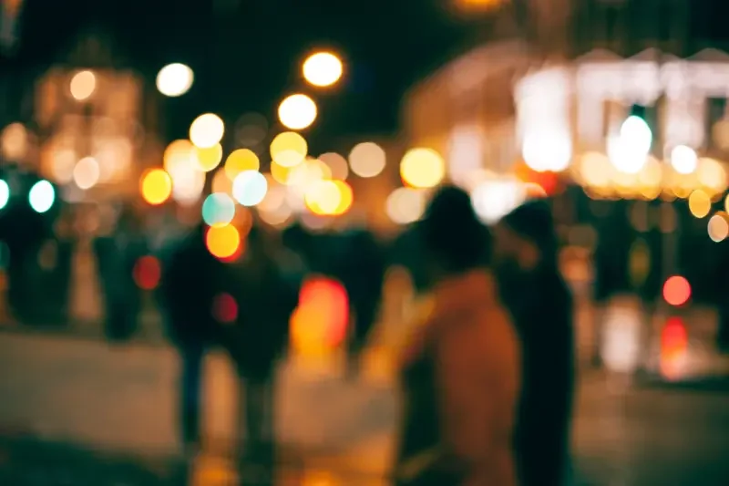A blurred photo of a crowded street. 