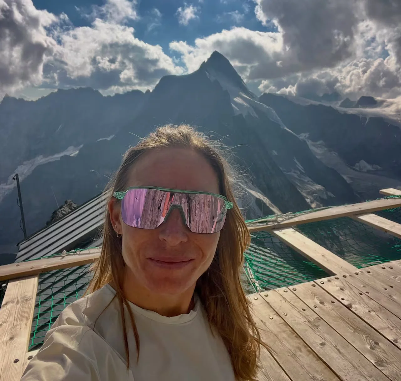 Woman in sunglasses with mountains in background